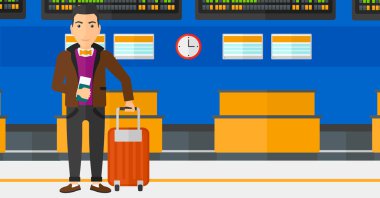 Man standing with suitcase and holding ticket.