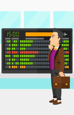 Man looking at schedule board.
