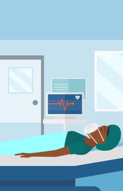 Patient lying in hospital bed with heart monitor.