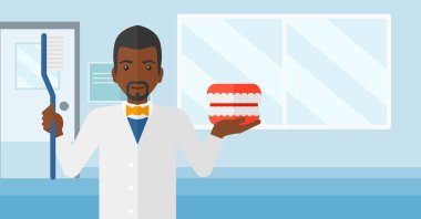 Dişçi diş çene modeli ve diş fırçası.