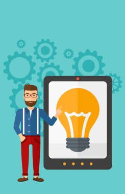 Man pointing at tablet computer with light bulb on screen.