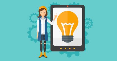 Woman pointing at tablet computer with light bulb on screen.