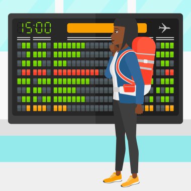 Woman looking at schedule board.