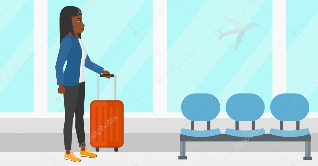 Woman at airport with suitcase.
