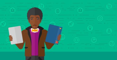 Man choosing between book and tablet computer.