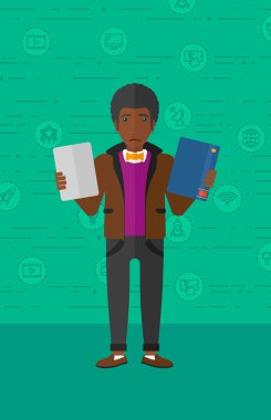 Man choosing between book and tablet computer.