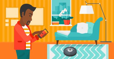 Man with robot vacuum cleaner.