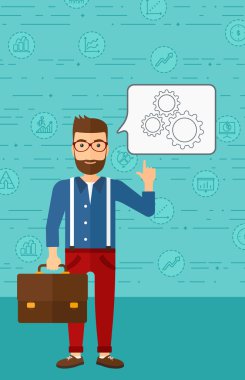 Businessman pointing at cogwheels.