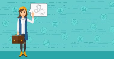 Business woman pointing at cogwheels.