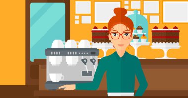 Barista ayakta yakınındaki kahve makinesi.