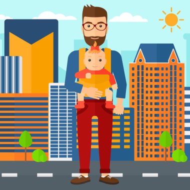 Adam tutarak bebek askı içinde.