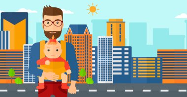 Adam tutarak bebek askı içinde.