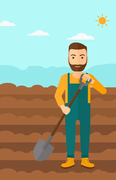 Agricultor en el campo con pala . — Vector de stock