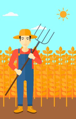 Çiftçi dirgen ile.