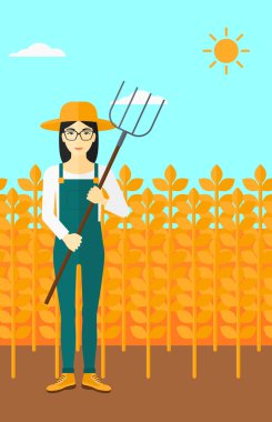 Çiftçi dirgen ile.