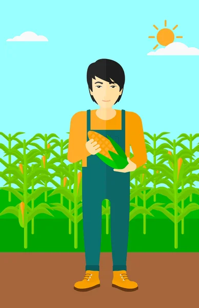 Фермер держит кукурузу . — стоковый вектор