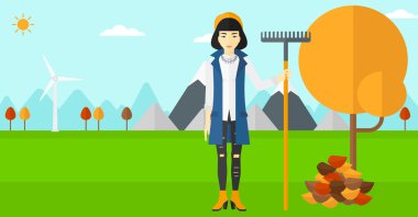 Komisyon duran ağaç ve sonbahar yaprak yığını yakınındaki kadınla.