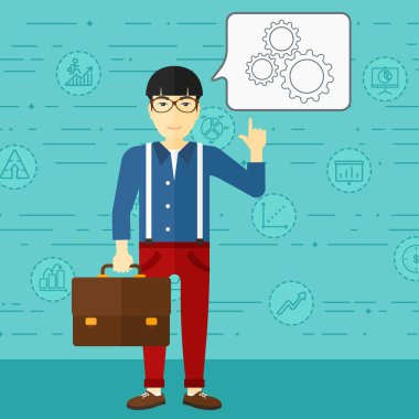 Businessman pointing at cogwheels.