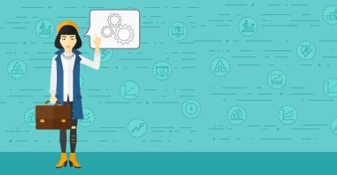 Business woman pointing at cogwheels.