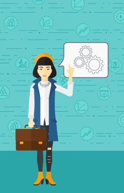 Business woman pointing at cogwheels.