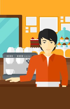 Barista ayakta yakınındaki kahve makinesi.