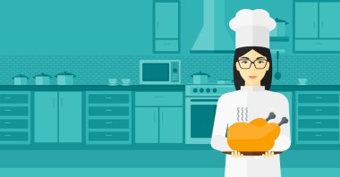 Woman holding roasted chicken.