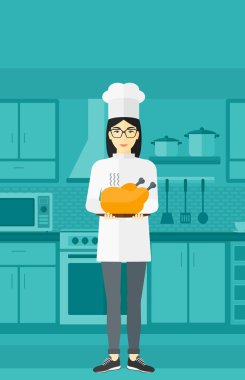 Woman holding roasted chicken.