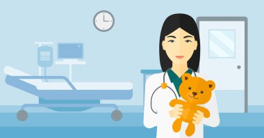 Çocuk doktoru holding oyuncak ayı.