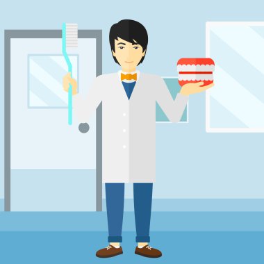 Dişçi diş çene modeli ve diş fırçası.