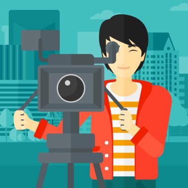 Cameraman with movie camera on a tripod.