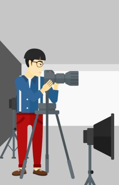 Photographer working with camera on a tripod.