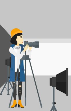 Photographer working with camera on a tripod.