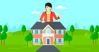 Emlakçı başparmak gösterilen.