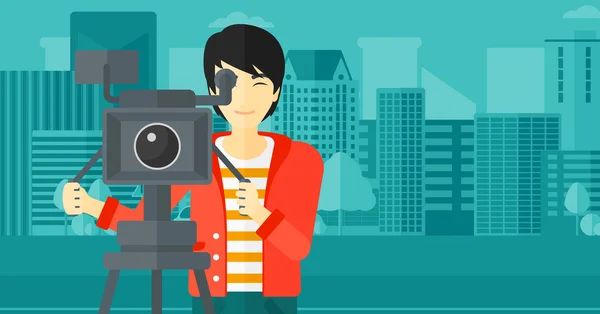 Cameraman with movie camera on a tripod. — Διανυσματικό Αρχείο