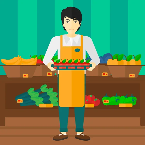Ouvrier de supermarché avec boîte pleine de pommes . — Image vectorielle