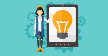 Woman pointing at tablet computer with light bulb on screen.