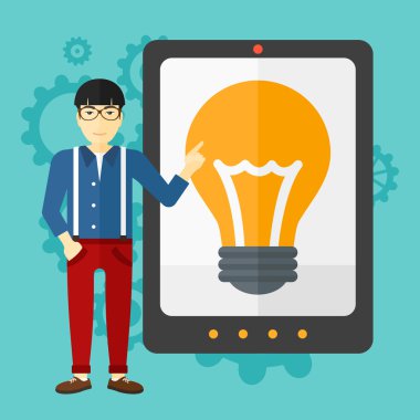 Man pointing at tablet computer with light bulb on screen.