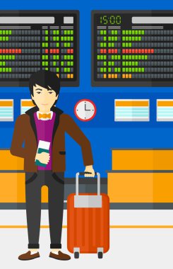 Man standing with suitcase and holding ticket.