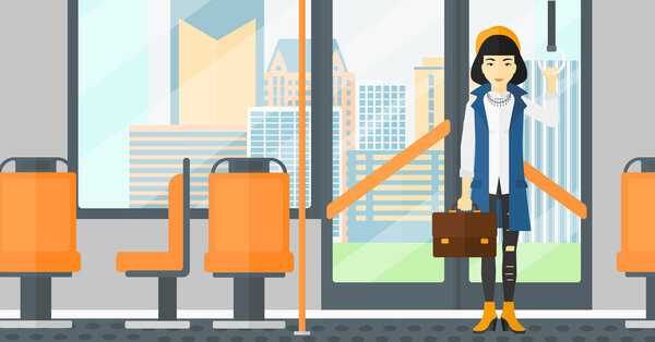 Woman standing inside public transport.