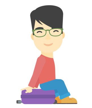 Bavulunu üzerinde oturan adam.