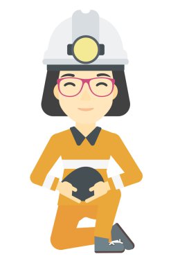 Madenci holding kömür elinde.