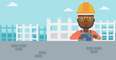 Duvarcı ustası spatula ve tuğla ile.