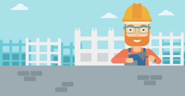 Duvarcı ustası spatula ve tuğla ile.