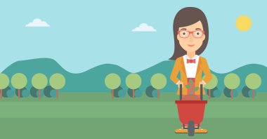 Bitki ve el arabası olan kadın.