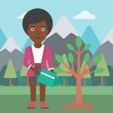 Kadın ağaç ampuller ile sulama.