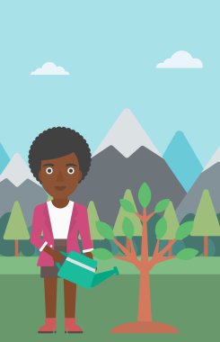 Kadın ağaç ampuller ile sulama.