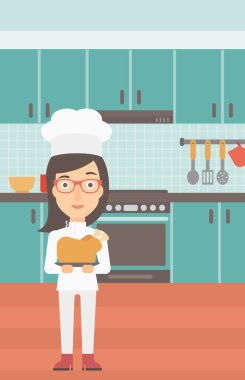 Woman holding roasted chicken.