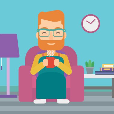 Çay sandalyeyle içinde oturan adam.