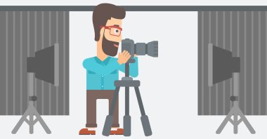 Photographer working with camera on a tripod.