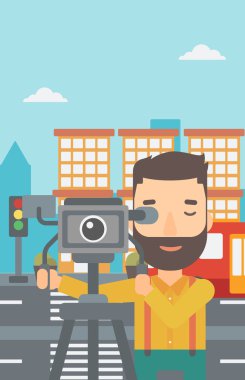 Cameraman with movie camera on a tripod.